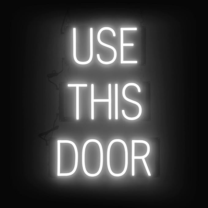 SpellBrite USE THIS DOOR Sign | Directional Sign with Neon Look, White LED Light Source | 17.4" x 23.8"